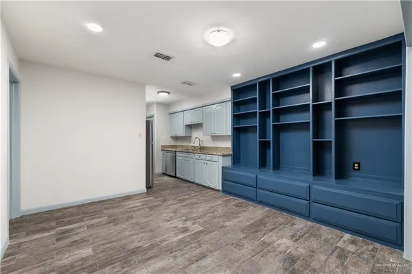 a kitchen with granite countertop white cabinets and a stainless steel appliances