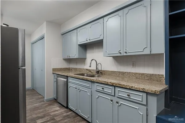 a kitchen with stainless steel appliances granite countertop a stove and a refrigerator