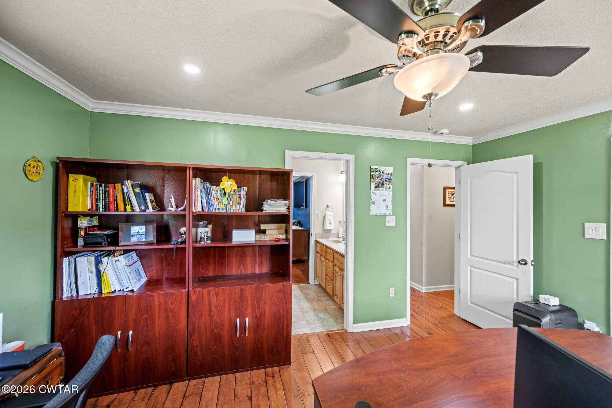 492 Joe Horton Road Lexington, TN 38351 - Photo 23 of 49 a living room with lots of furniture and a book shelf