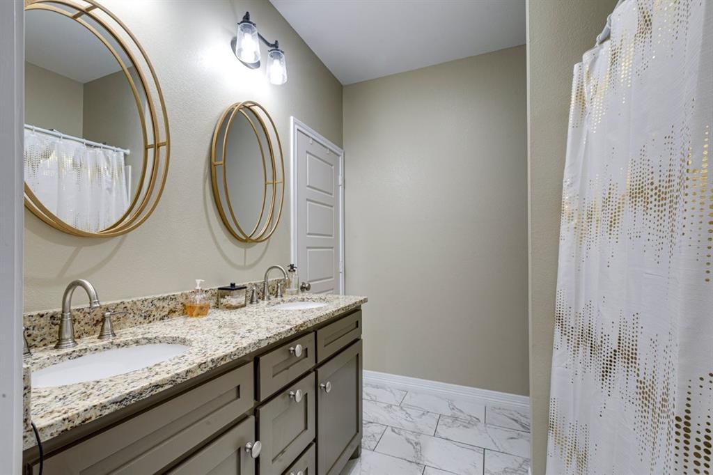 206 Willowbrook Avenue Tyler, TX 75702 - Photo 17 of 25 a bathroom with a granite countertop double vanity and a mirror