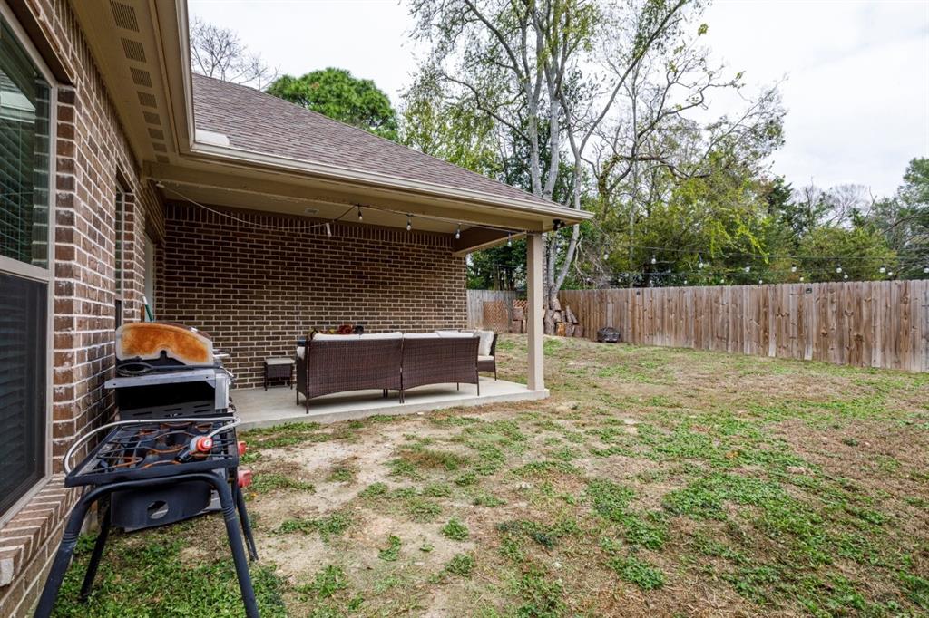 206 Willowbrook Avenue Tyler, TX 75702 - Photo 22 of 25 a view of backyard with barbeque grill and wooden fence