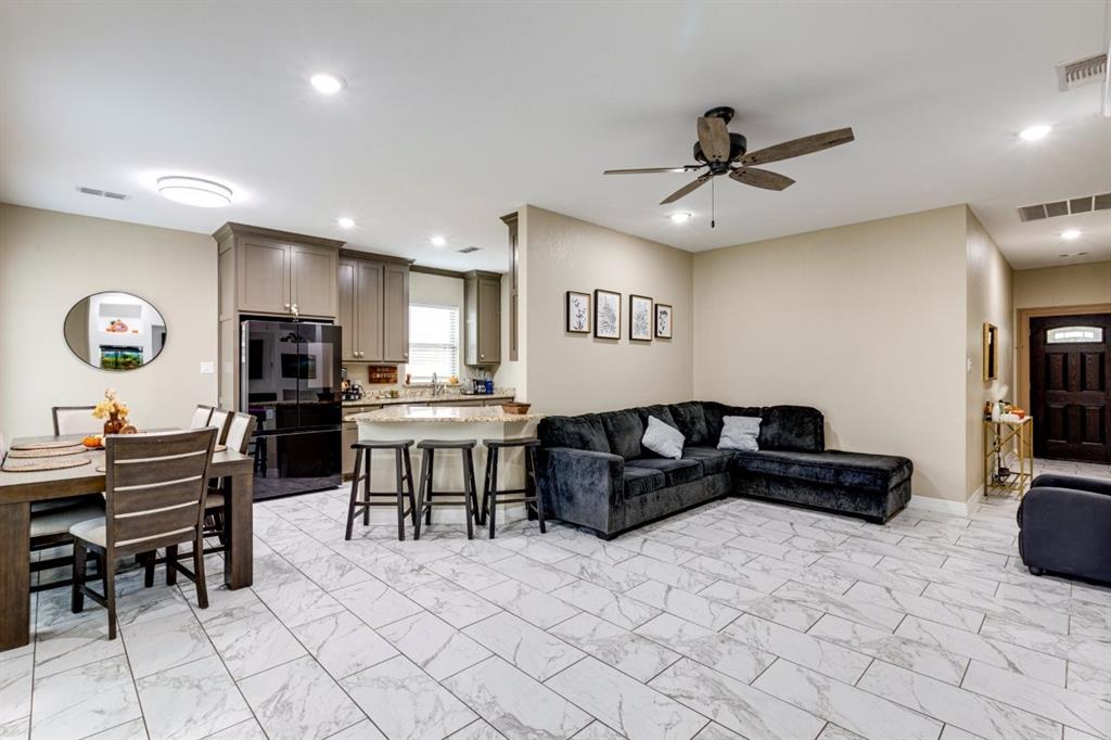 206 Willowbrook Avenue Tyler, TX 75702 - Photo 8 of 25 a living room with stainless steel appliances kitchen island granite countertop furniture and a fireplace