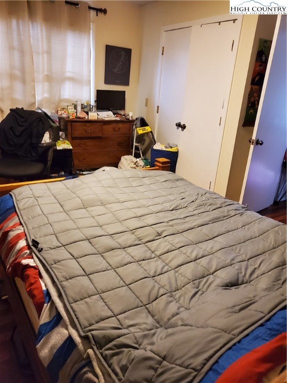 116 Grand Boulevard, Unit 1J Boone, NC 28607 - Photo 11 of 17 a bedroom with a bed and a chair