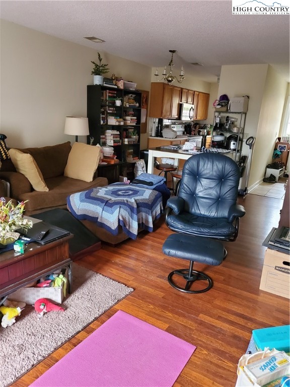 116 Grand Boulevard, Unit 1J Boone, NC 28607 - Photo 6 of 17 a living room with furniture and wooden floor