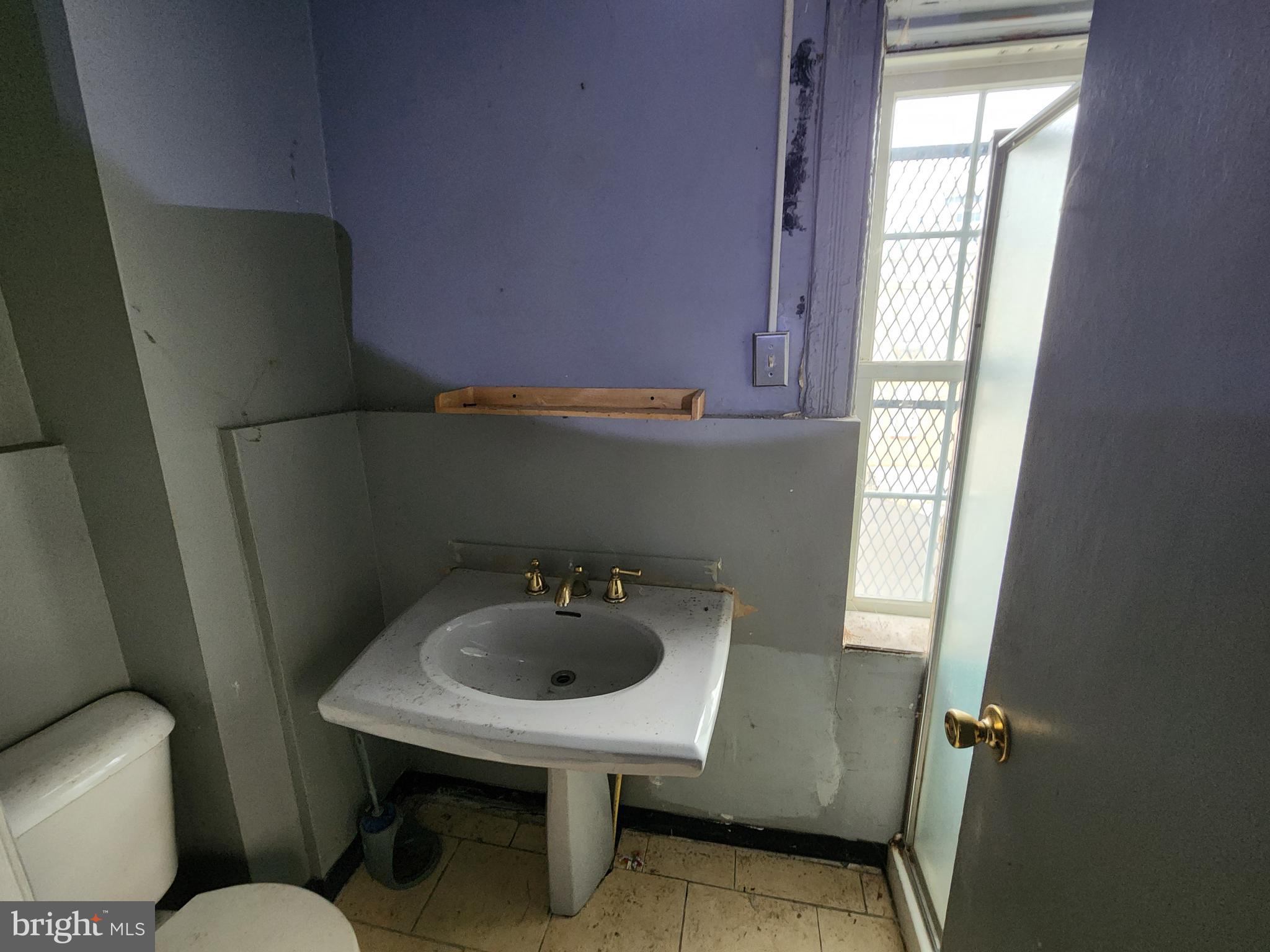 526 North Chester Street Baltimore, MD 21205 - Photo 12 of 26 a bathroom with a sink toilet and mirror