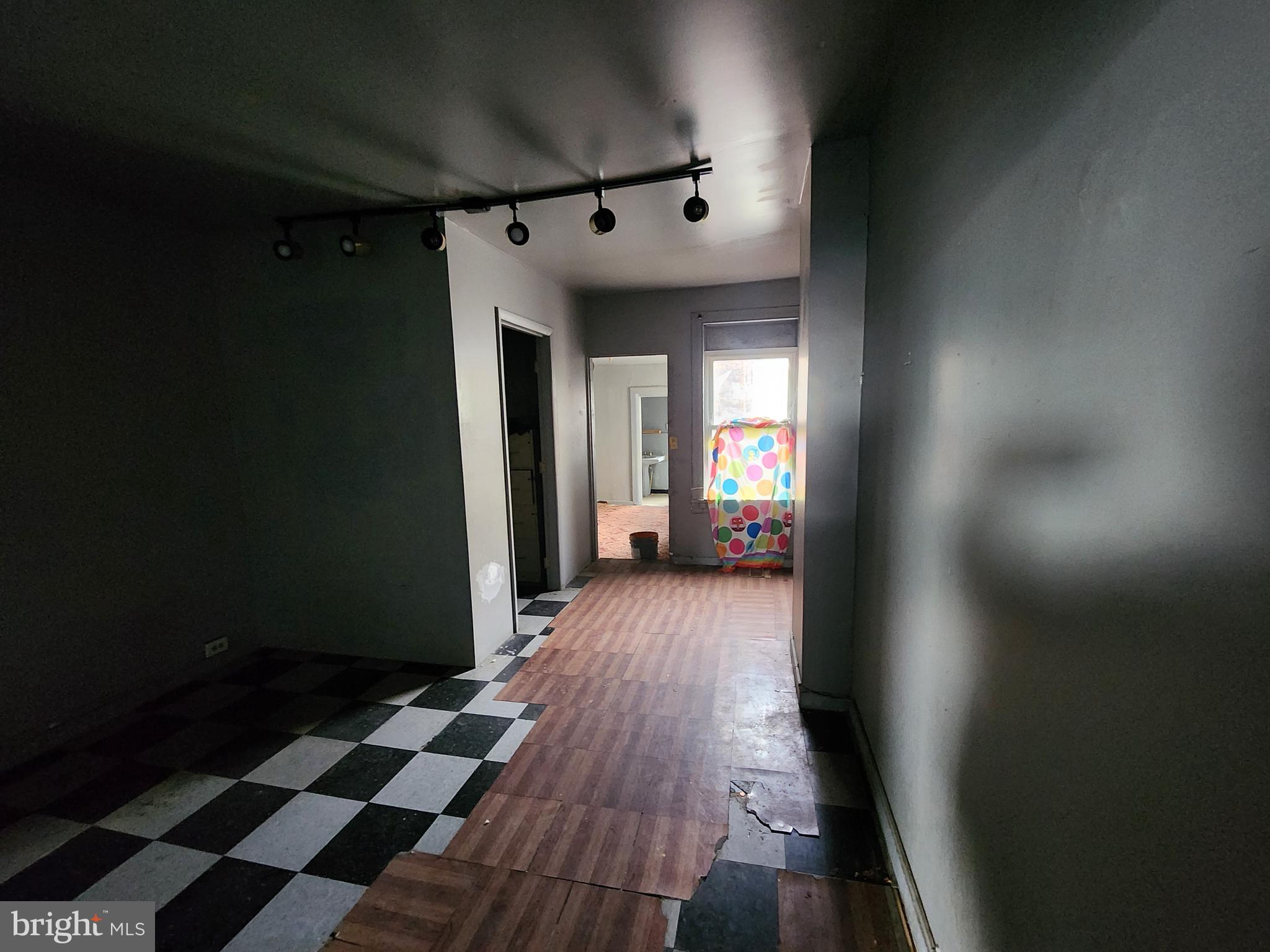 526 North Chester Street Baltimore, MD 21205 - Photo 18 of 26 a view of a hallway with wooden floor and a living room