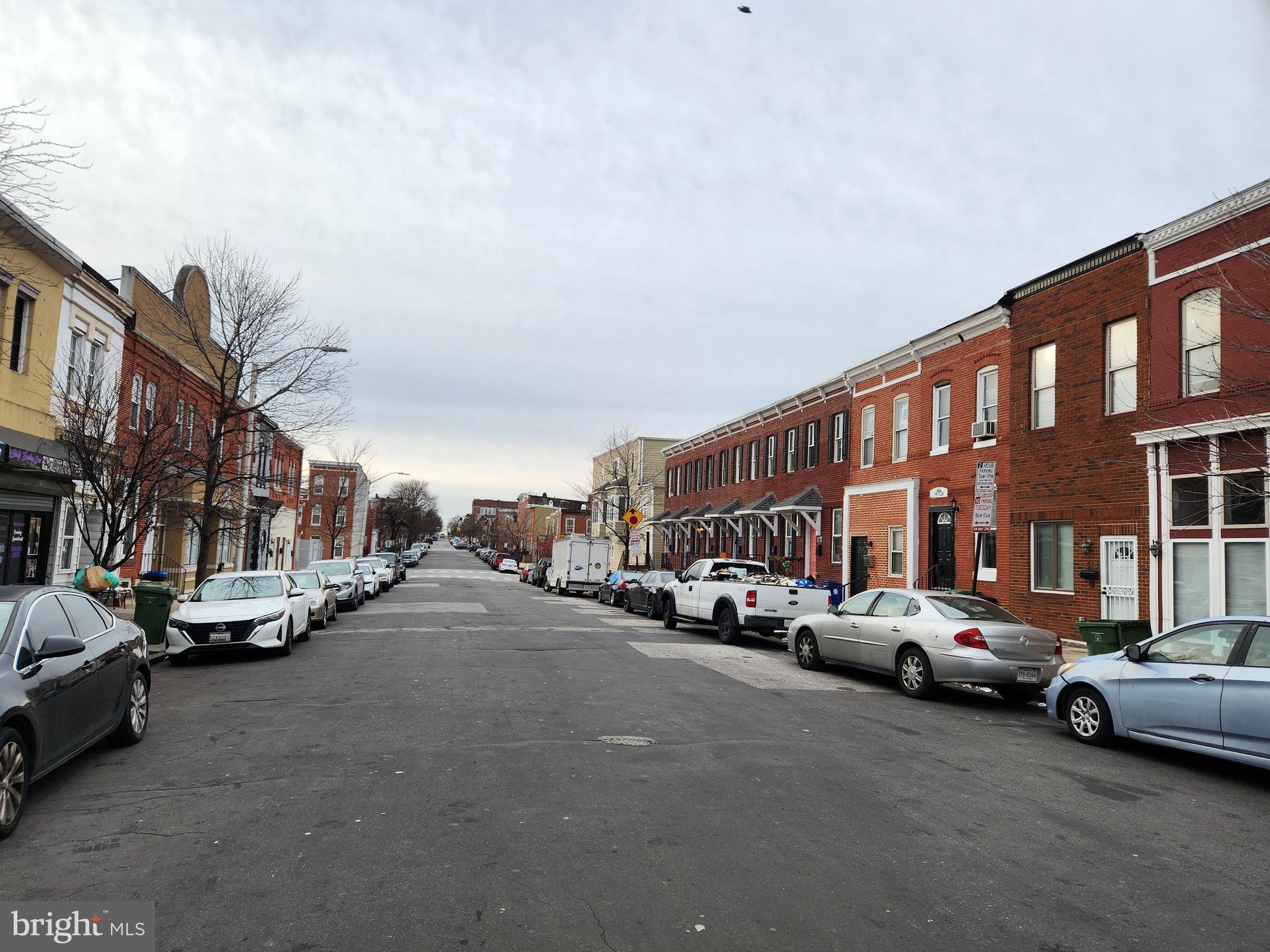 526 North Chester Street Baltimore, MD 21205 - Photo 25 of 26 a city street lined with parked cars and buildings