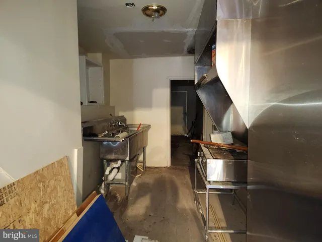 a view of hallway with wooden floor