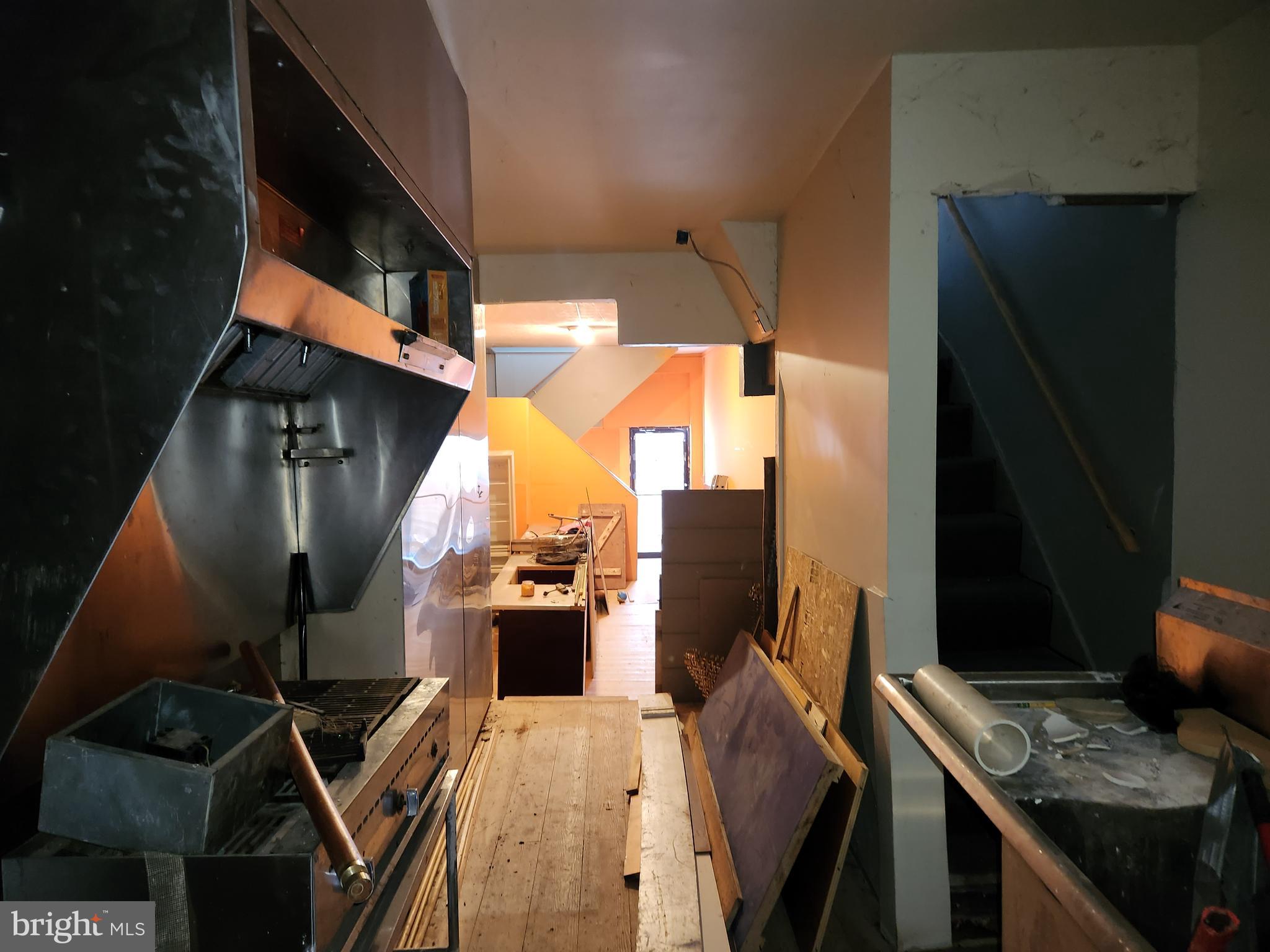 526 North Chester Street Baltimore, MD 21205 - Photo 7 of 26 a view of workspace with wooden floor windows fireplace and wooden floor