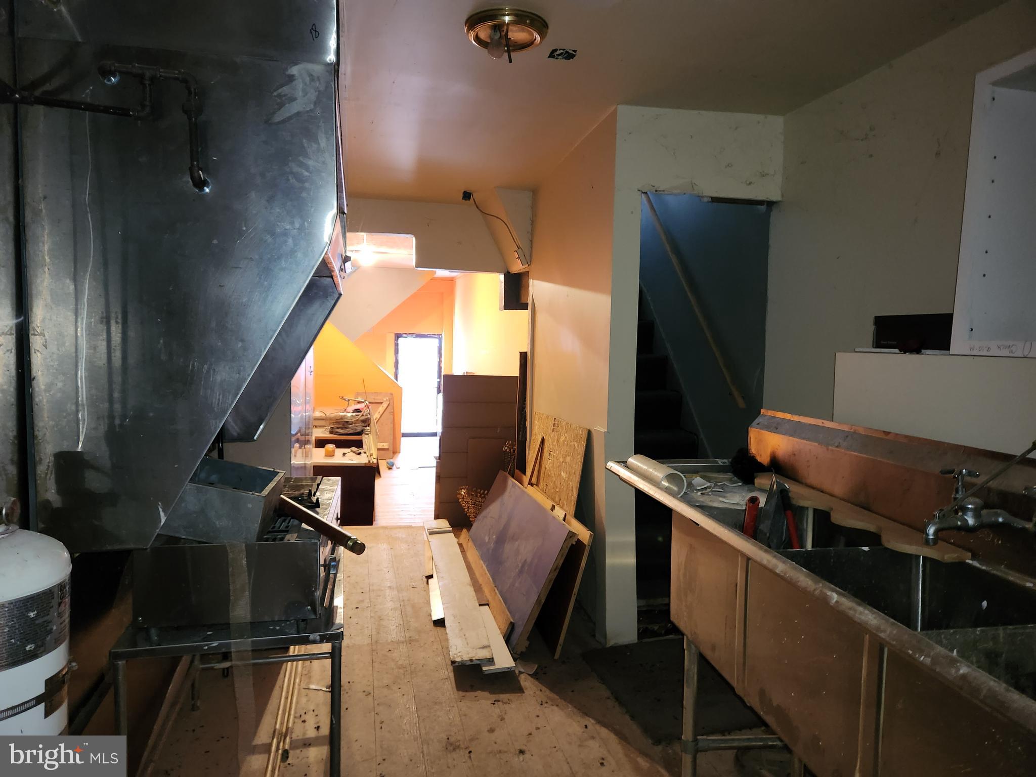 526 North Chester Street Baltimore, MD 21205 - Photo 10 of 26 a kitchen with a wooden floor and a stove