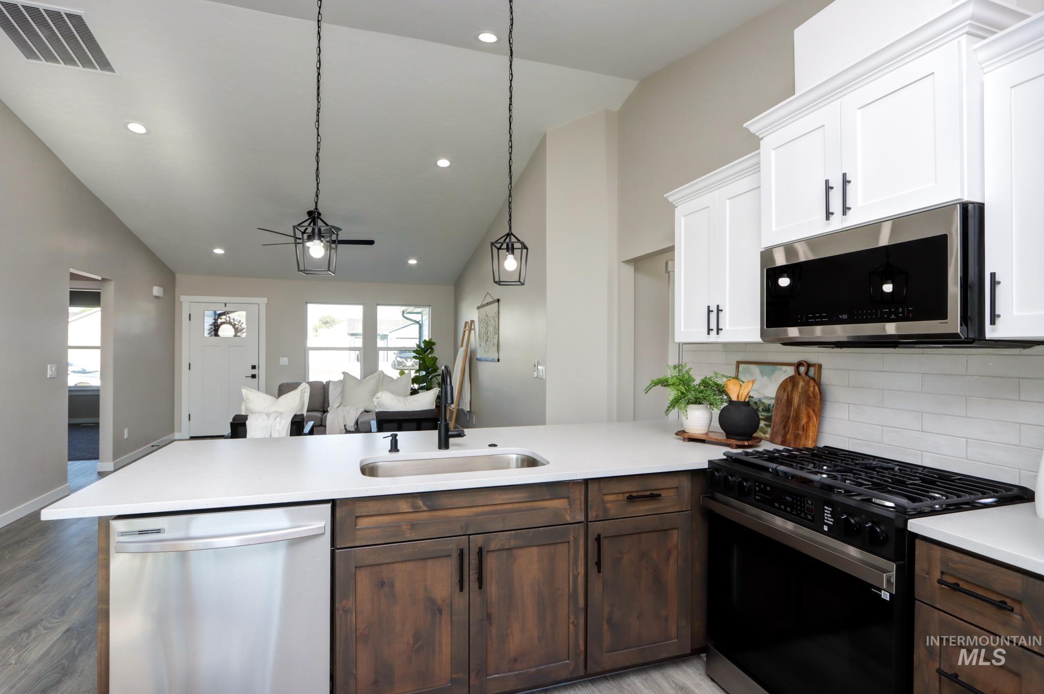 848 North 5th Street Nyssa, OR 97913 - Photo 5 of 49 Modern kitchen featuring a gas range, stainless steel appliances, and a subway tile backsplash