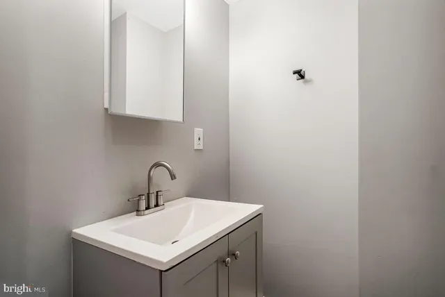 a bathroom with a sink and mirror