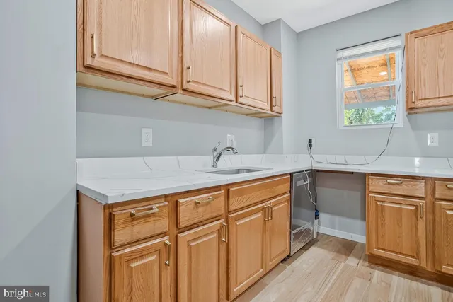 a kitchen with stainless steel appliances granite countertop a sink and dishwasher cabinets with wooden floor