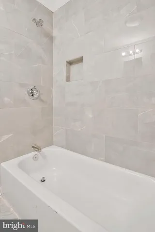 a bathroom with a bathtub and shower