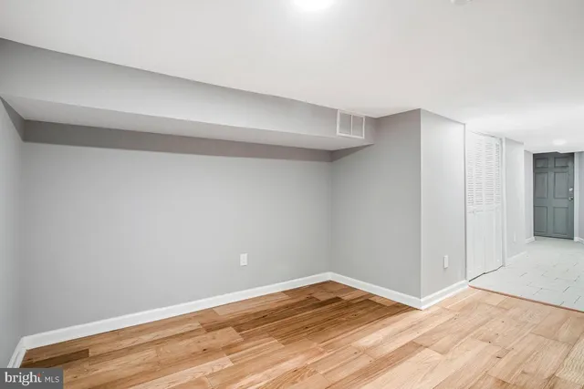 a view of a room with wooden floor