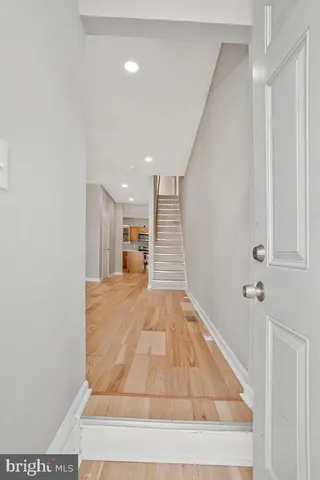 a view of hallway with a rug and a window