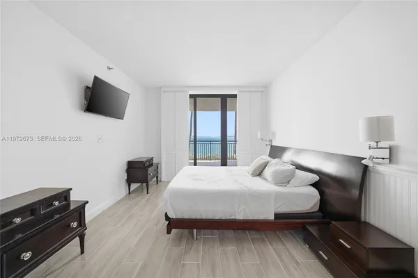 a bedroom with a bed and a television