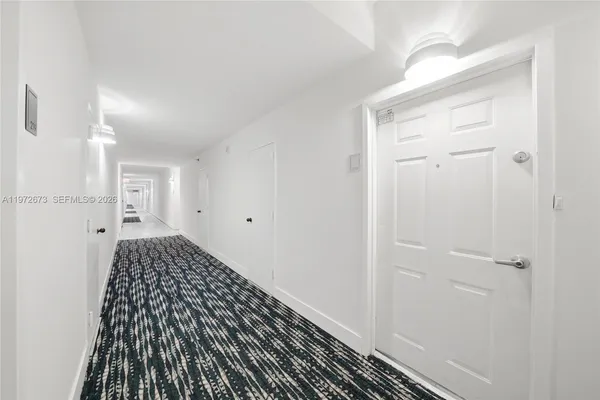 a view of a bedroom with wooden floor