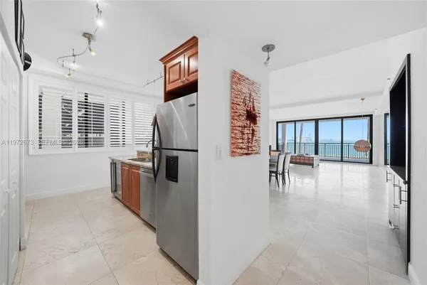 a kitchen with stainless steel appliances granite countertop a refrigerator and a stove top oven