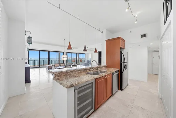 a kitchen with stainless steel appliances granite countertop a stove and a refrigerator