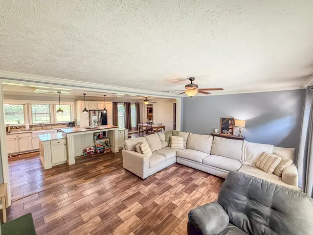 a kitchen with stainless steel appliances granite countertop a lot of counter space and wooden floor