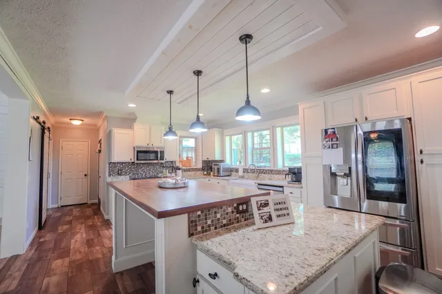 a view of a workspace with furniture and a flat screen tv