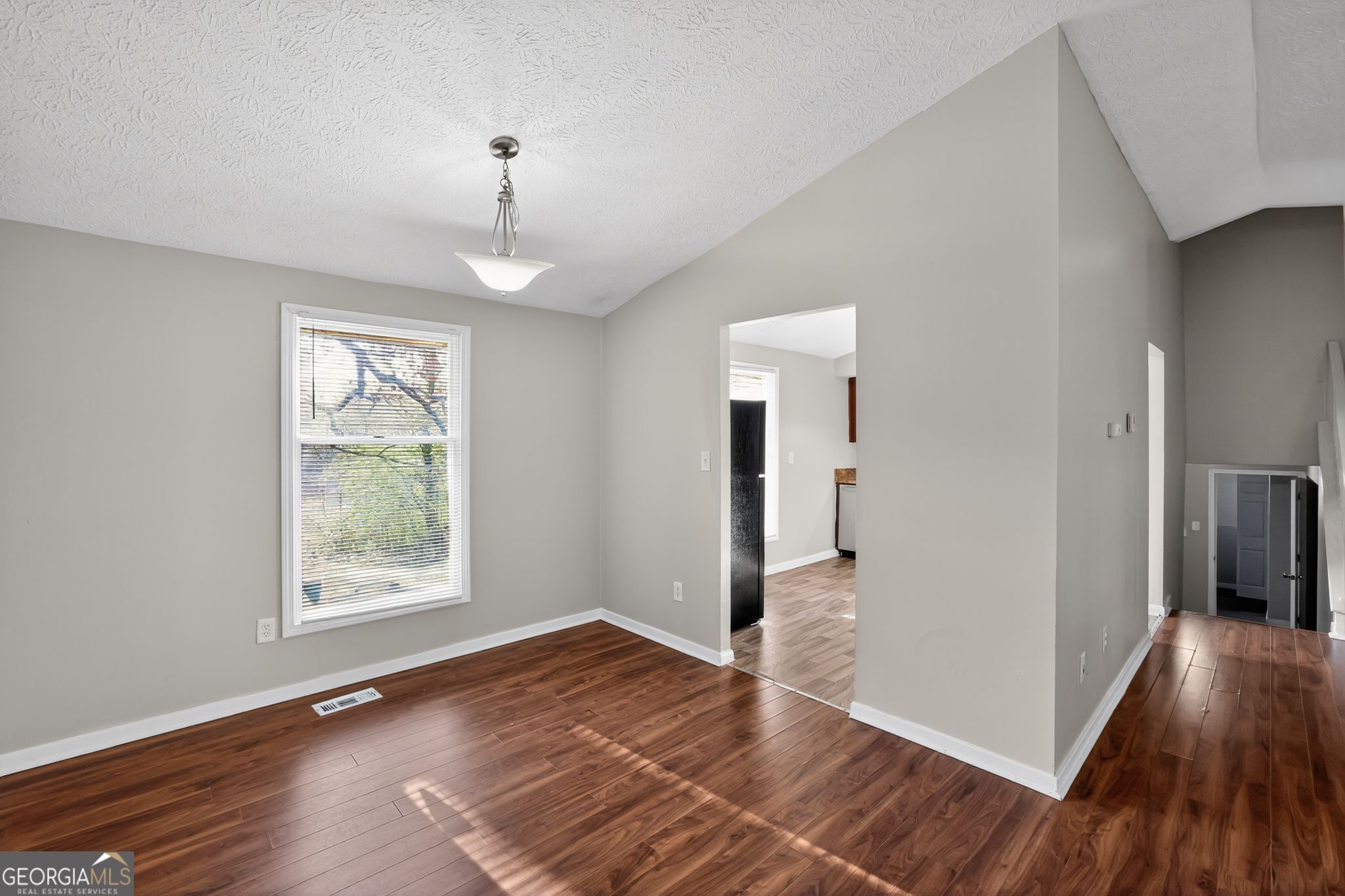 3798 Radcliffe Boulevard Decatur, GA 30034 - Photo 11 of 32 a view of an empty room with window and wooden floor