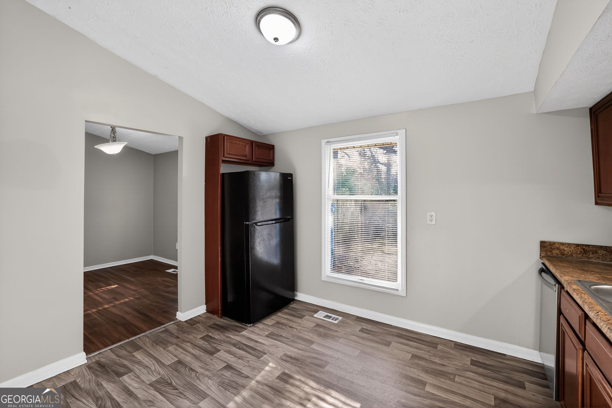 3798 Radcliffe Boulevard Decatur, GA 30034 - Photo 13 of 32 a view of a kitchen with refrigerator and wooden floor