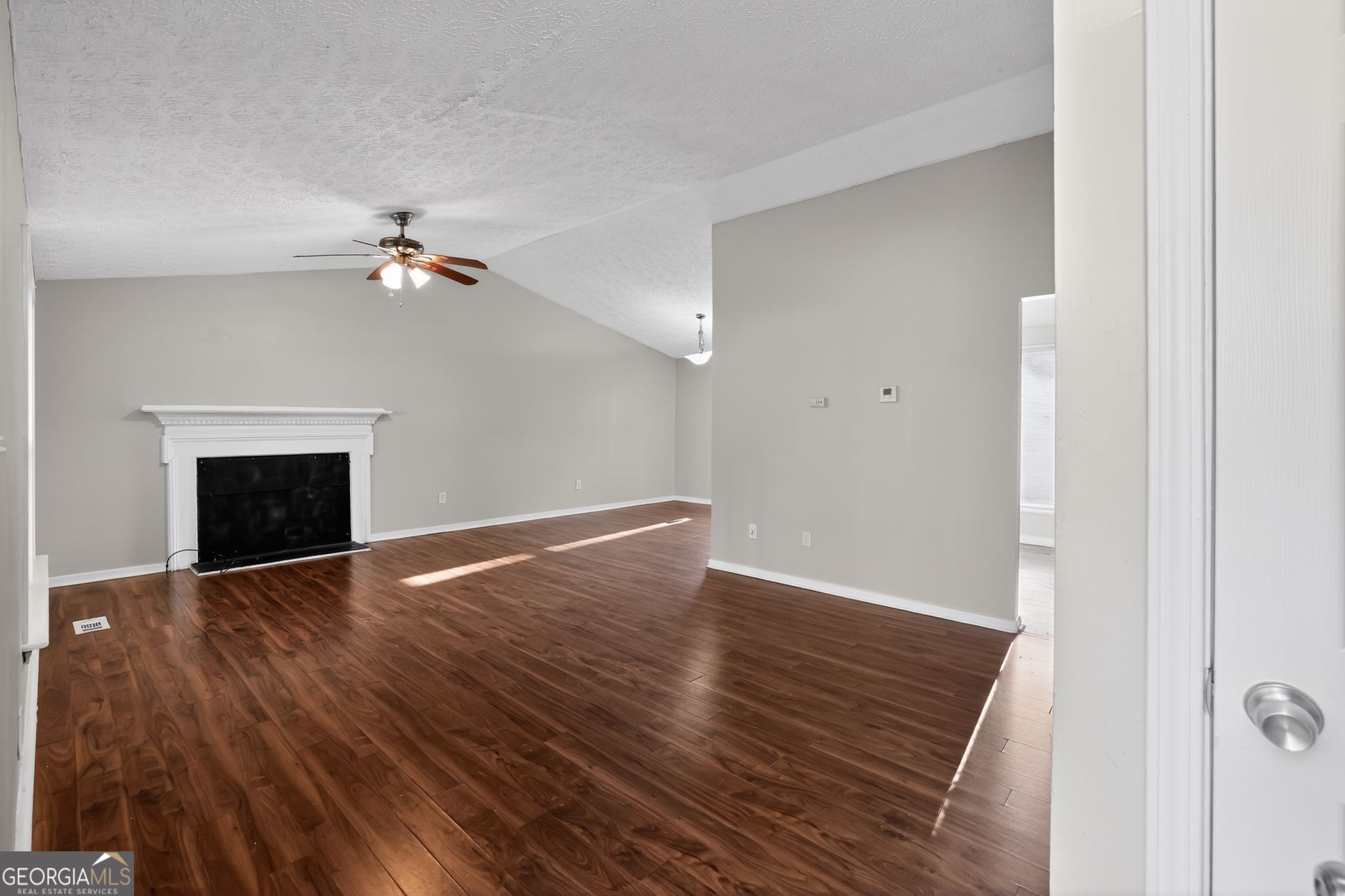 3798 Radcliffe Boulevard Decatur, GA 30034 - Photo 8 of 32 an empty room with wooden floor and fireplace
