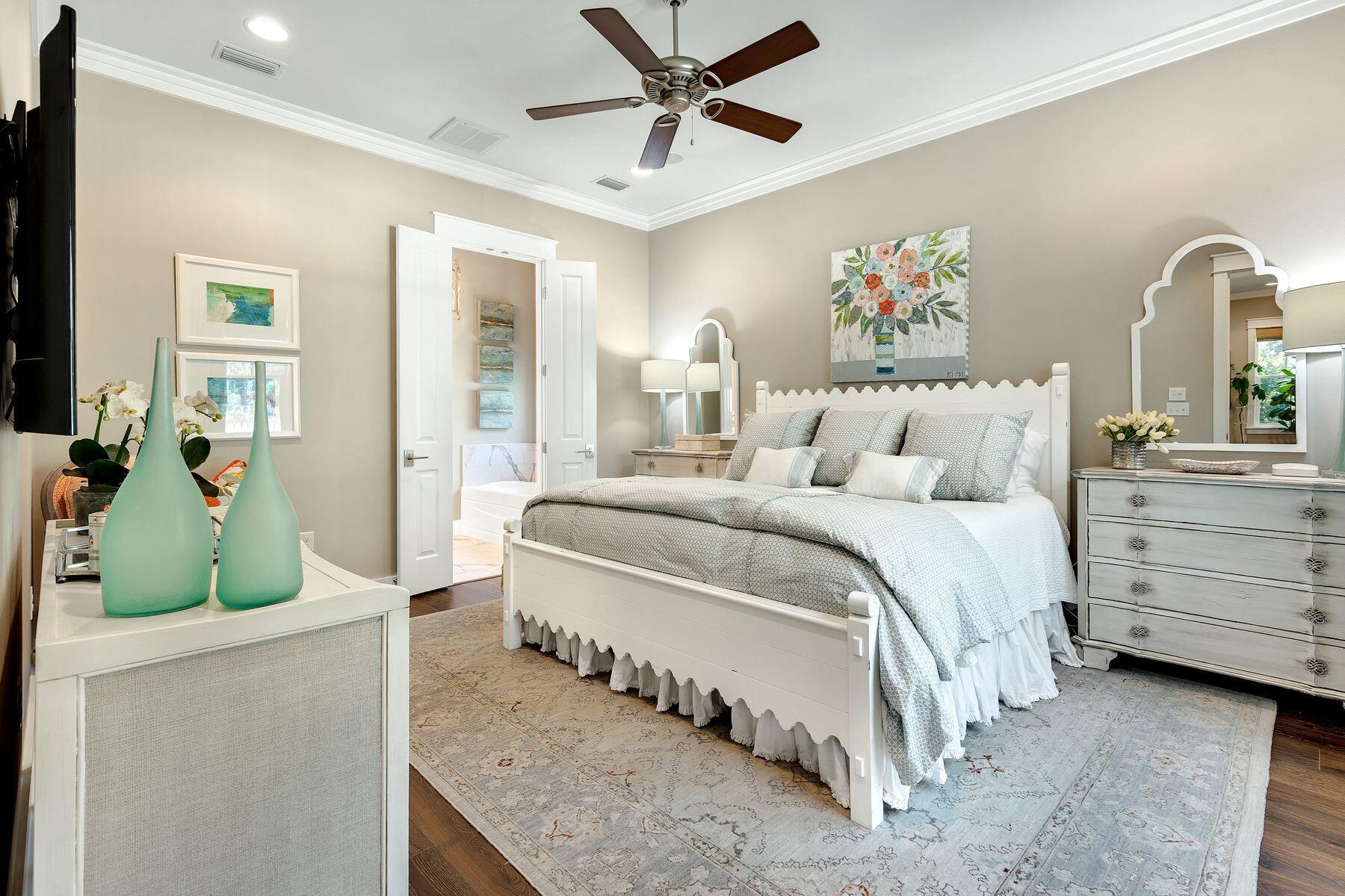 150 Medley Street Watersound, FL 32461 - Photo 11 of 30 a bedroom with a bed and a dresser
