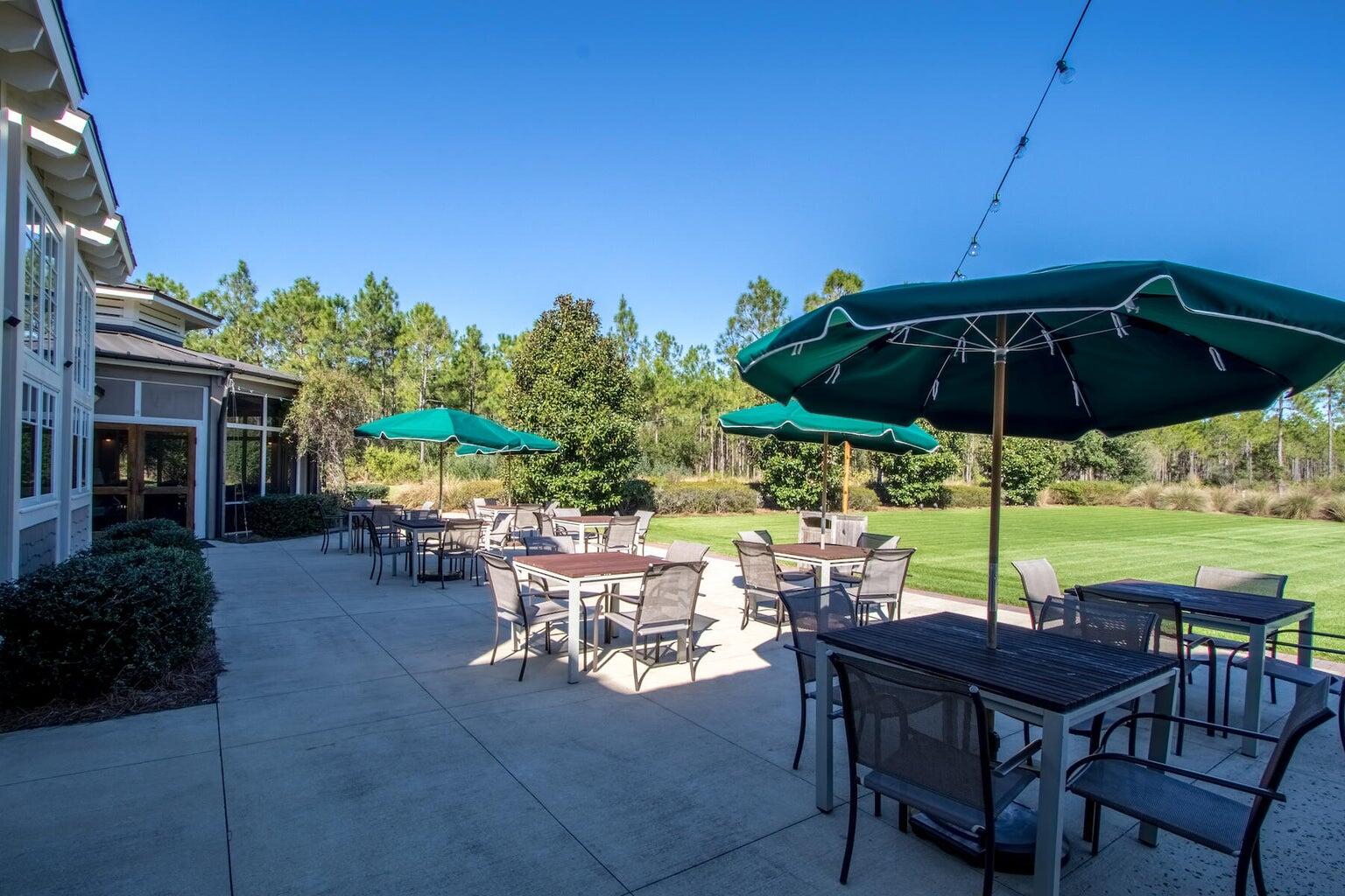 150 Medley Street Watersound, FL 32461 - Photo 27 of 30 a view of chairs and table under an umbrella with a fire pit
