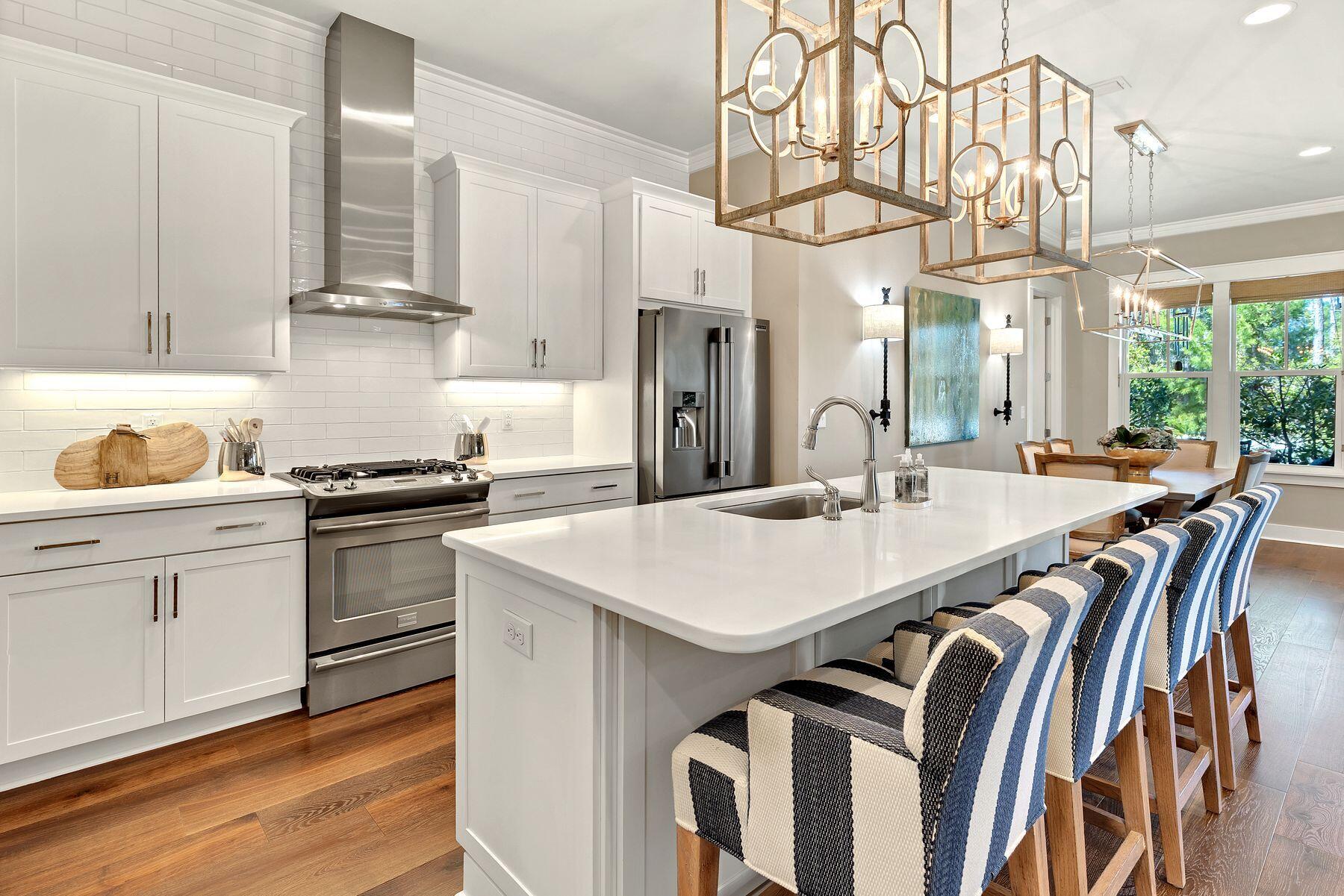 150 Medley Street Watersound, FL 32461 - Photo 4 of 30 a kitchen with a white cabinets a sink dishwasher and a stove with wooden floor