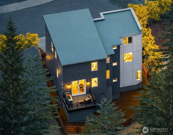 an aerial view of a house with yard swimming pool and outdoor seating
