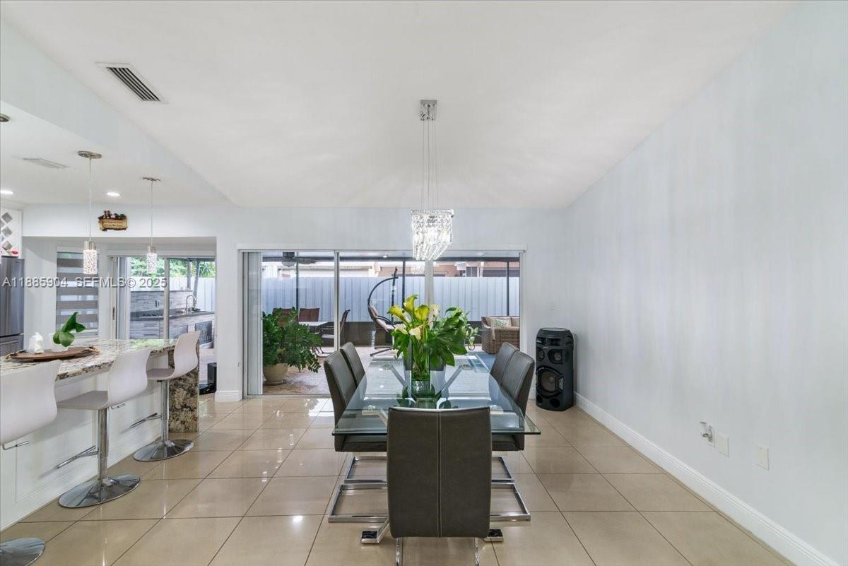 14500 Southwest 173rd Street Miami, FL 33177 - Photo 12 of 47 a dining room with furniture and a potted plant