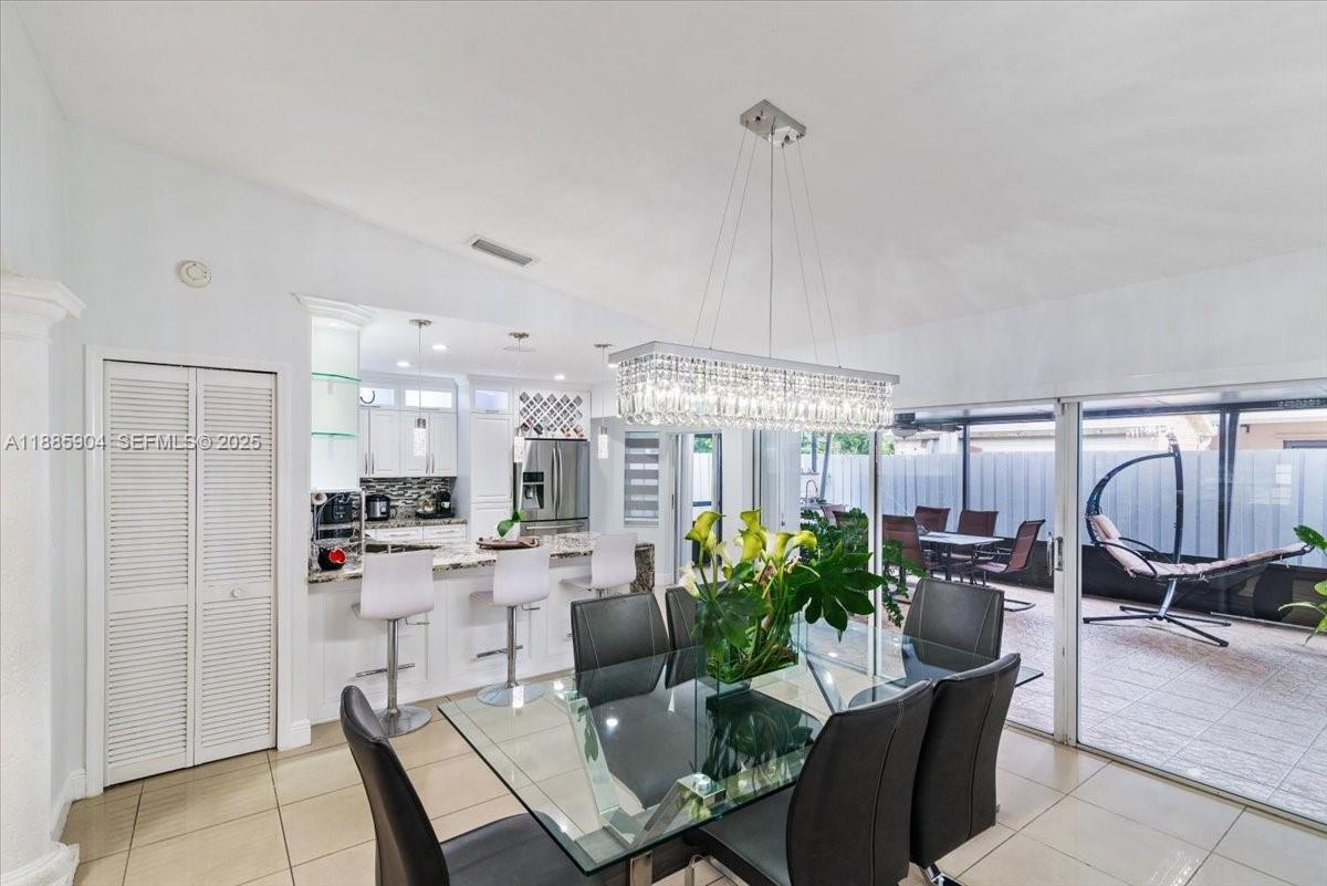 14500 Southwest 173rd Street Miami, FL 33177 - Photo 13 of 47 a living room with lots of furniture and a chandelier