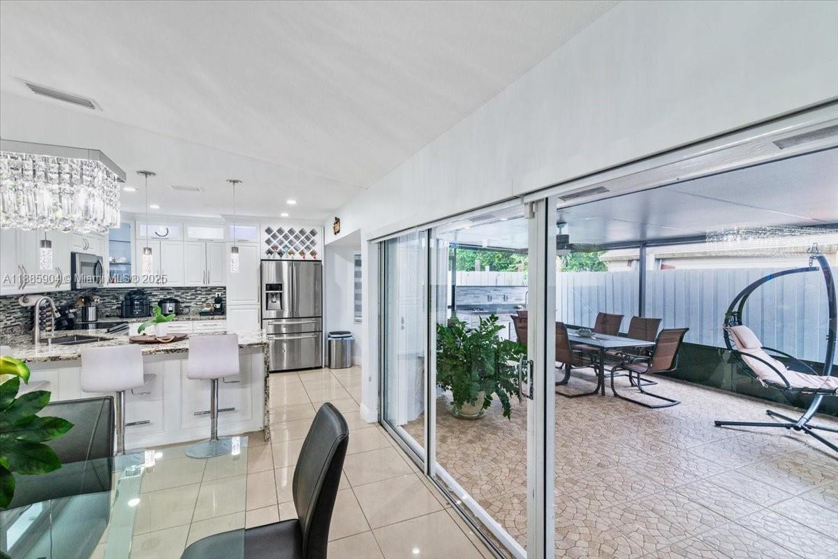 14500 Southwest 173rd Street Miami, FL 33177 - Photo 15 of 47 a dining room with furniture and a floor to ceiling window