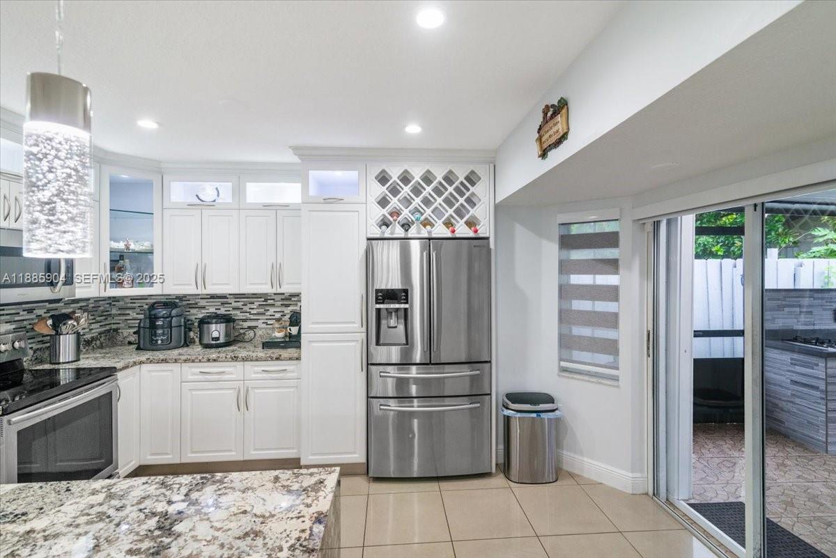 14500 Southwest 173rd Street Miami, FL 33177 - Photo 18 of 47 a kitchen with a stove top oven and refrigerator