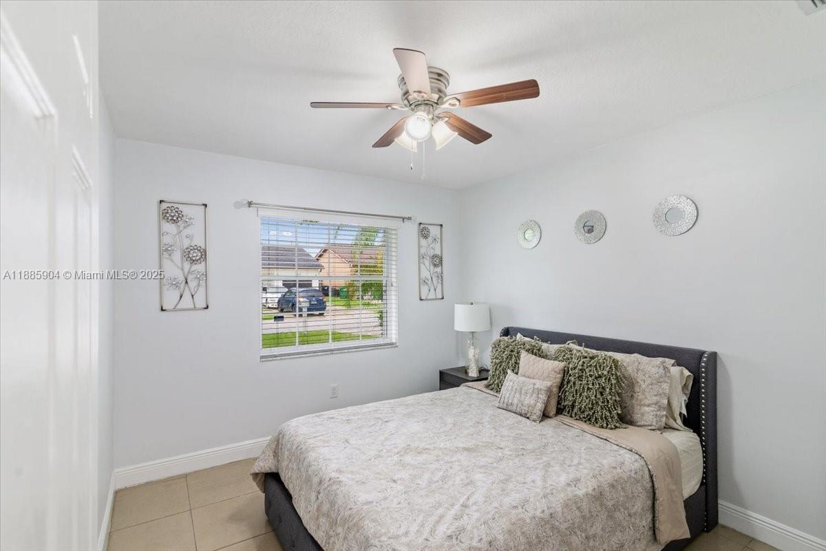 14500 Southwest 173rd Street Miami, FL 33177 - Photo 24 of 47 a bedroom with a bed and a window