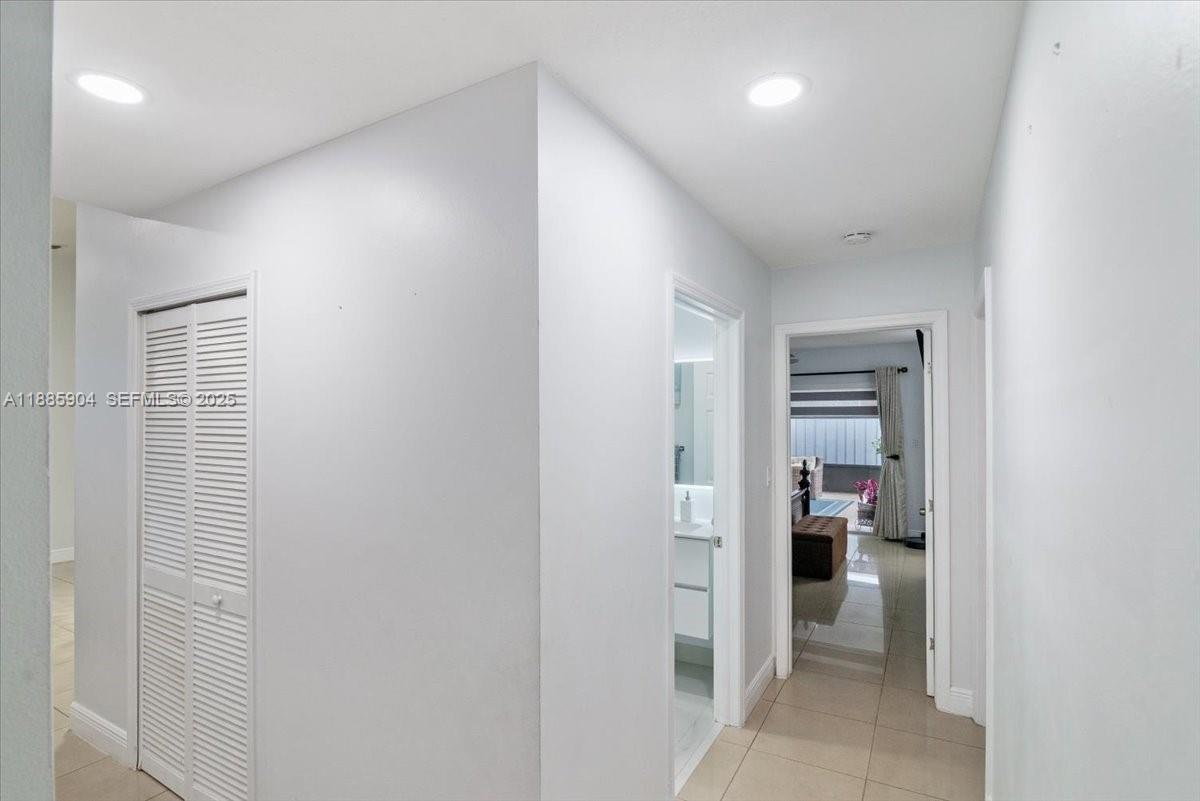 14500 Southwest 173rd Street Miami, FL 33177 - Photo 25 of 47 a view of hallway with walk in closet and a bathroom