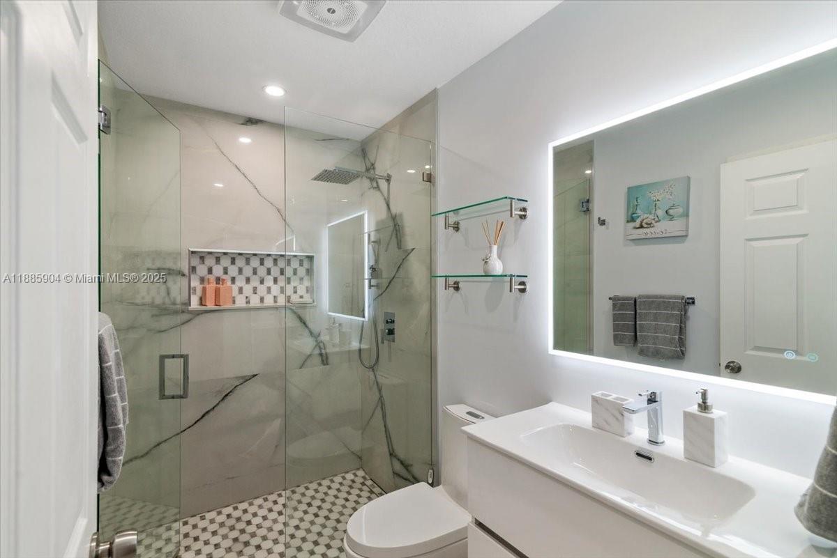 14500 Southwest 173rd Street Miami, FL 33177 - Photo 26 of 47 a bathroom with a sink toilet and shower