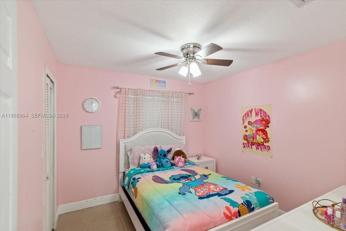 14500 Southwest 173rd Street Miami, FL 33177 - Photo 27 of 47 a bedroom with a bed and a chandelier
