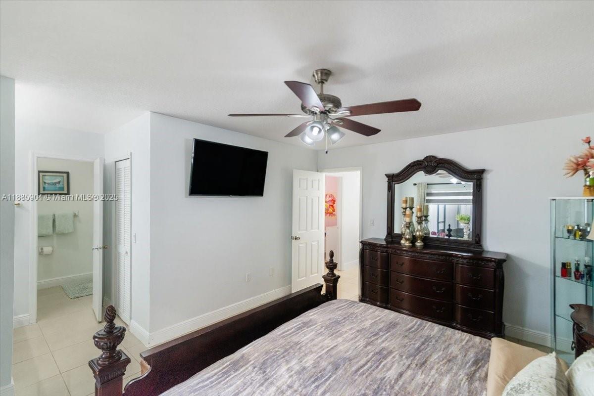 14500 Southwest 173rd Street Miami, FL 33177 - Photo 29 of 47 a bedroom with a bed and a flat tv screen on dresser