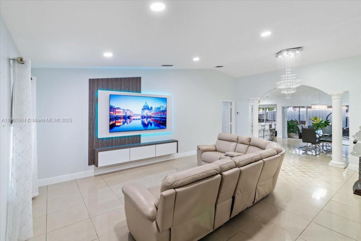 14500 Southwest 173rd Street Miami, FL 33177 - Photo 3 of 47 a living room with furniture and a flat screen tv