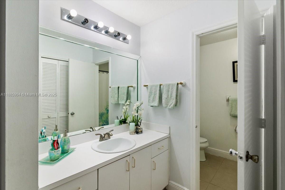 14500 Southwest 173rd Street Miami, FL 33177 - Photo 31 of 47 a bathroom with a sink vanity and mirror