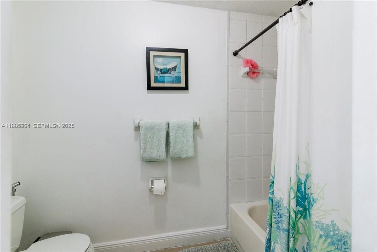 14500 Southwest 173rd Street Miami, FL 33177 - Photo 32 of 47 a bathroom with a shower and toilet