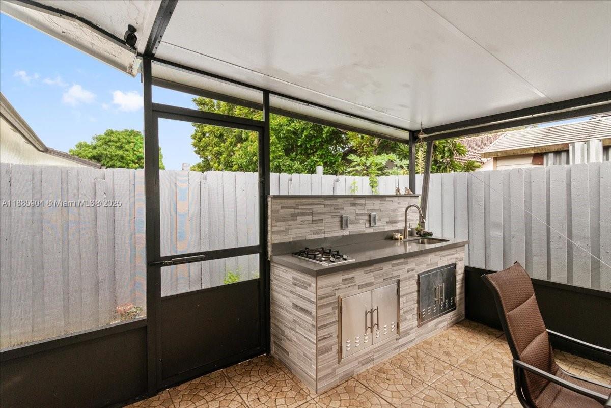 14500 Southwest 173rd Street Miami, FL 33177 - Photo 37 of 47 a kitchen that has a stove and a wooden floor