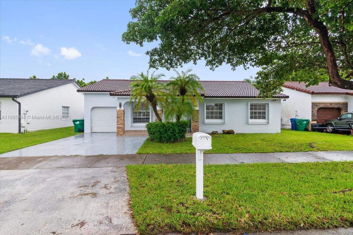 14500 Southwest 173rd Street Miami, FL 33177 - Photo 41 of 47 a front view of a house with a yard