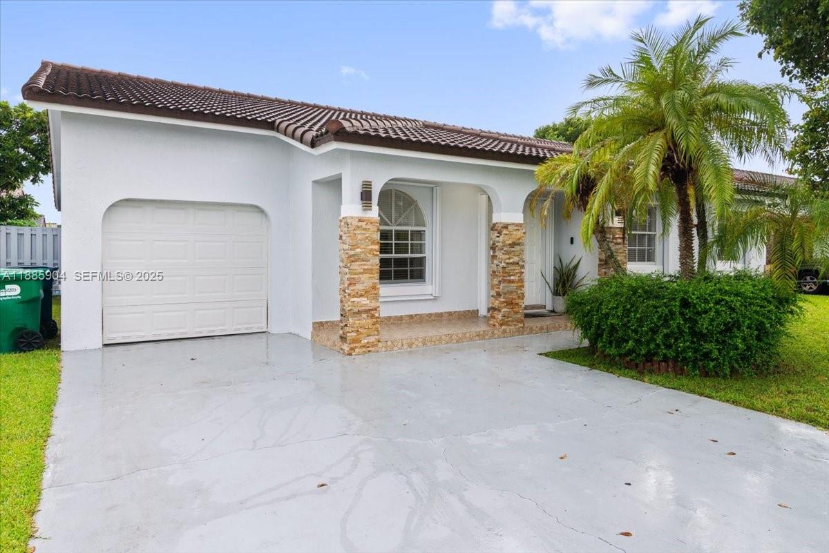 14500 Southwest 173rd Street Miami, FL 33177 - Photo 42 of 47 a view of a house with a yard and garage