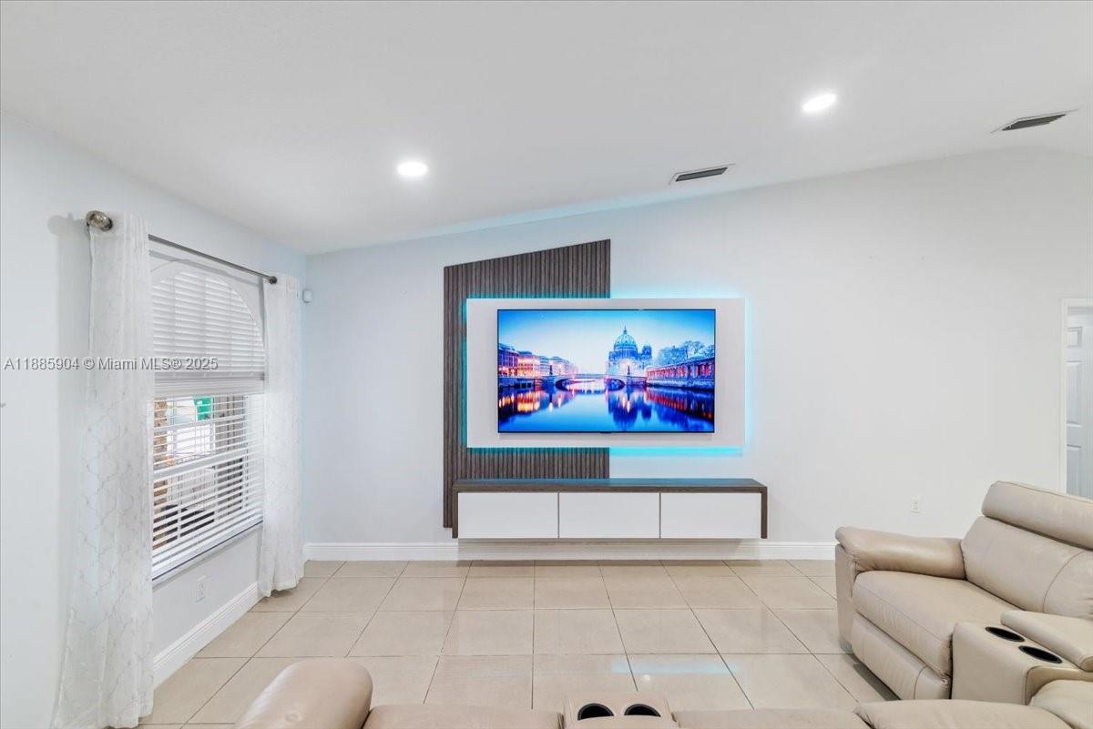14500 Southwest 173rd Street Miami, FL 33177 - Photo 5 of 47 a living room with furniture and a flat screen tv