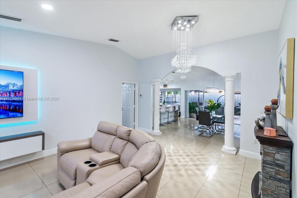 14500 Southwest 173rd Street Miami, FL 33177 - Photo 6 of 47 a living room with furniture a chandelier and a dining table